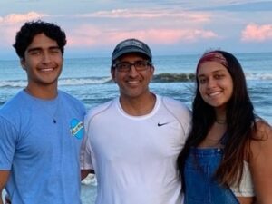 Man poses for photo with his children