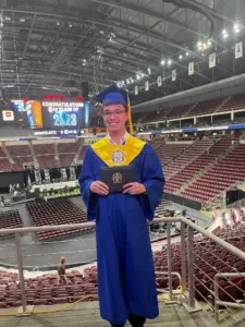 A high school graduate poses for a photo.